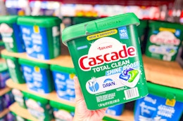 hand holding up a pack of cascade dishwasher pacs