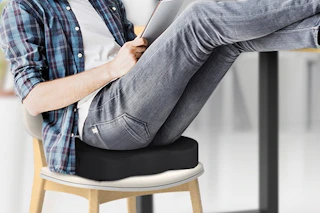 a man sitting on a seat cushion