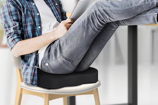 a man sitting on a seat cushion