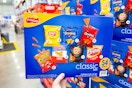 hand holding a frito lay chips variety pack at costco