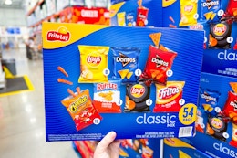 hand holding a frito lay chips variety pack at costco