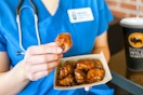 a nurse eating wings from buffalo wild wings