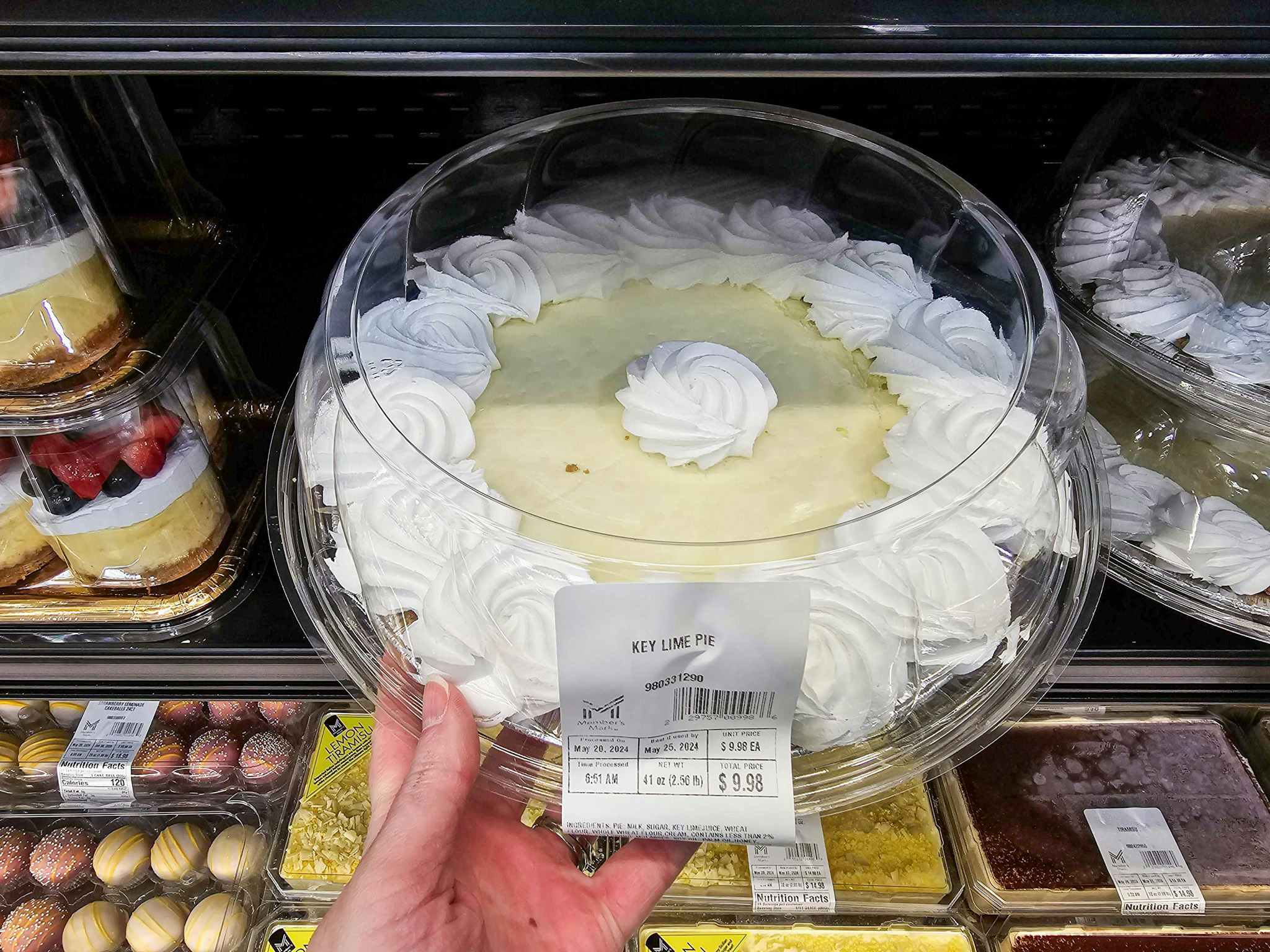 person grabbing a key lime pie out of a cooler