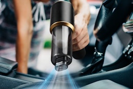 Person using the JIXINMIYUE Car Handheld Vacuum Cordless inside their car.