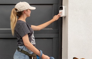 a person using a keypad at a garage door