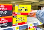 hand grabbing a box of cafe bustelo coffee k-cups