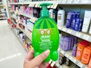 hand holding raw sugar kids shampoo in aisle at walgreens