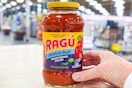 hand holding a jar of ragu pasta sauce