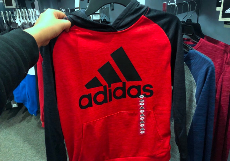 Person holding an Adidas sweatshirt