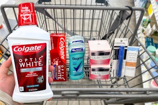 hand putting mouthwash in a shopping cart