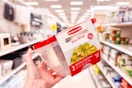 hand holding a rubbermaid serving bowl set in a target aisle