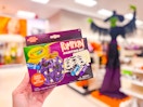 hand holding a crayola pumpkin paint kit at target