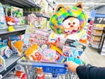 hand pushing assorted toys in walmart cart