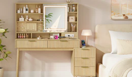a vanity desk next to a bed in a room
