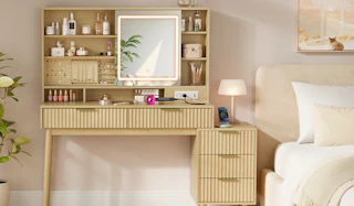 a vanity desk next to a bed in a room
