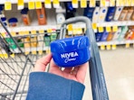 hand holding nivea creme in walgreens