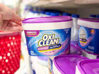hand grabbing a oxiclean tub off a target shelf