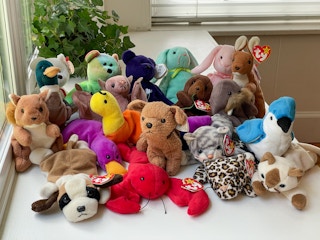 A large pile of rare Beanie Babies sitting by a window.