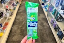 person holding a gillette disposable razor in an aisle
