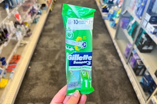 person holding a gillette disposable razor in an aisle