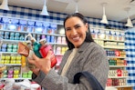 a woman shopping at Bath & Body Works with her hands full of products