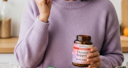 a person holding a bottle of supplements