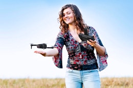 Lifestyle image of the AUOSHI Mini Drone being used by a woman outdoors