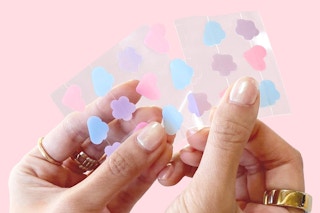 a woman holding grace & stella pimple patches