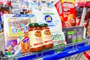 hot pockets, body wash, pasta sauce, detergent, cereal, and applesauce pouches in a cart