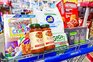 hot pockets, body wash, pasta sauce, detergent, cereal, and applesauce pouches in a cart