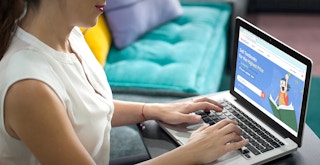 person looking at bookdeal website to sell books online feature