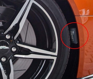 key hider case behind a car tire