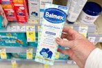 person holding a box of balmex diaper rash cream