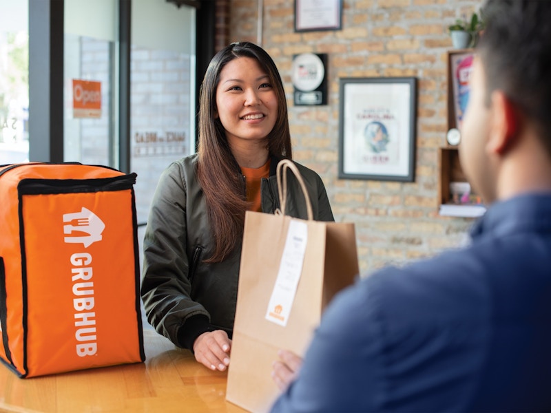 a grubhub driver picking up an order from a restaurant