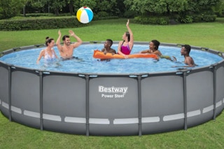 family playing volleyball in an above ground pool