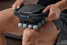 massage gun being used on thigh
