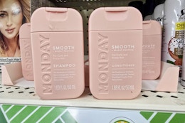travel size monday shampoo and conditioner on a shelf