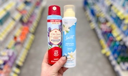 hand holding old spice and secret spray deodorants in walgreens