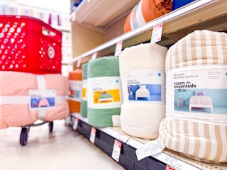 Room Essentials comforters in Target store with shopping cart in background