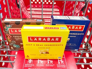 A variety of Larabar boxes sitting in a store cart.