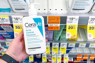 hand holding bottle of cerave facial cleanser next to clearance tag on shelf