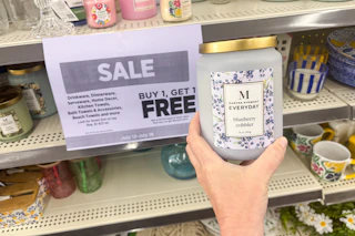 hand holding a martha stewart candle