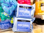 two packs of neutrogena makeup wipes next to loofahs