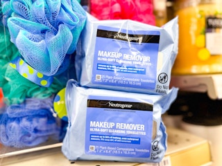 two packs of neutrogena makeup wipes next to loofahs