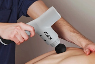someone using a massage gun