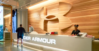 A customer standing at the Under Armour checkout counter