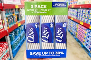 hand holding a pack of q tips