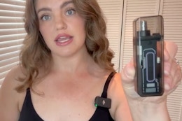 a woman holding a nose hair trimmer