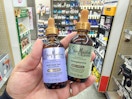 hand holding sheamoisture hair oils in walgreens