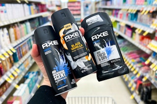 hand holding axe deodorants and sprays